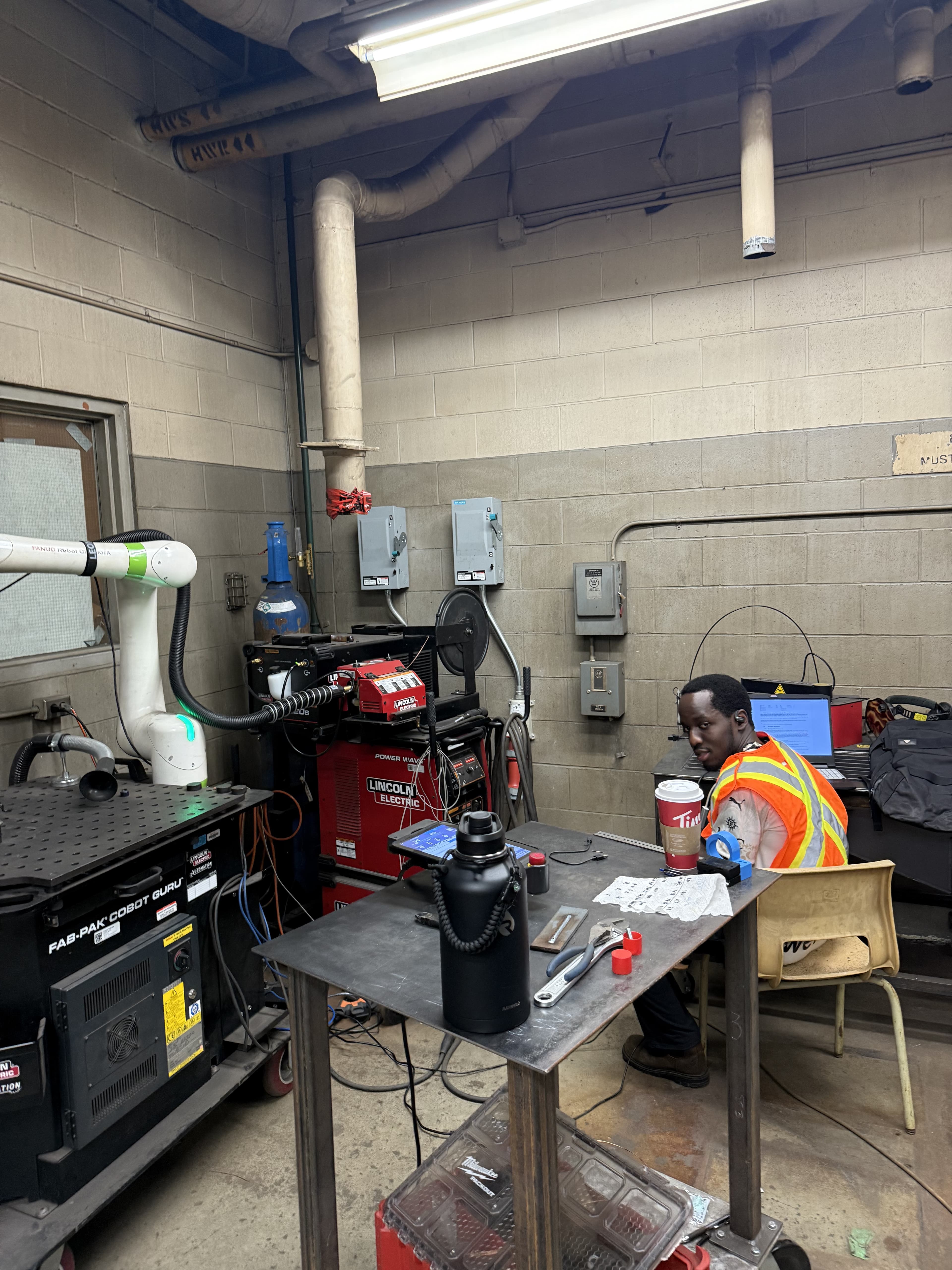 Working in the BCIT Steel Trades robotic welding lab